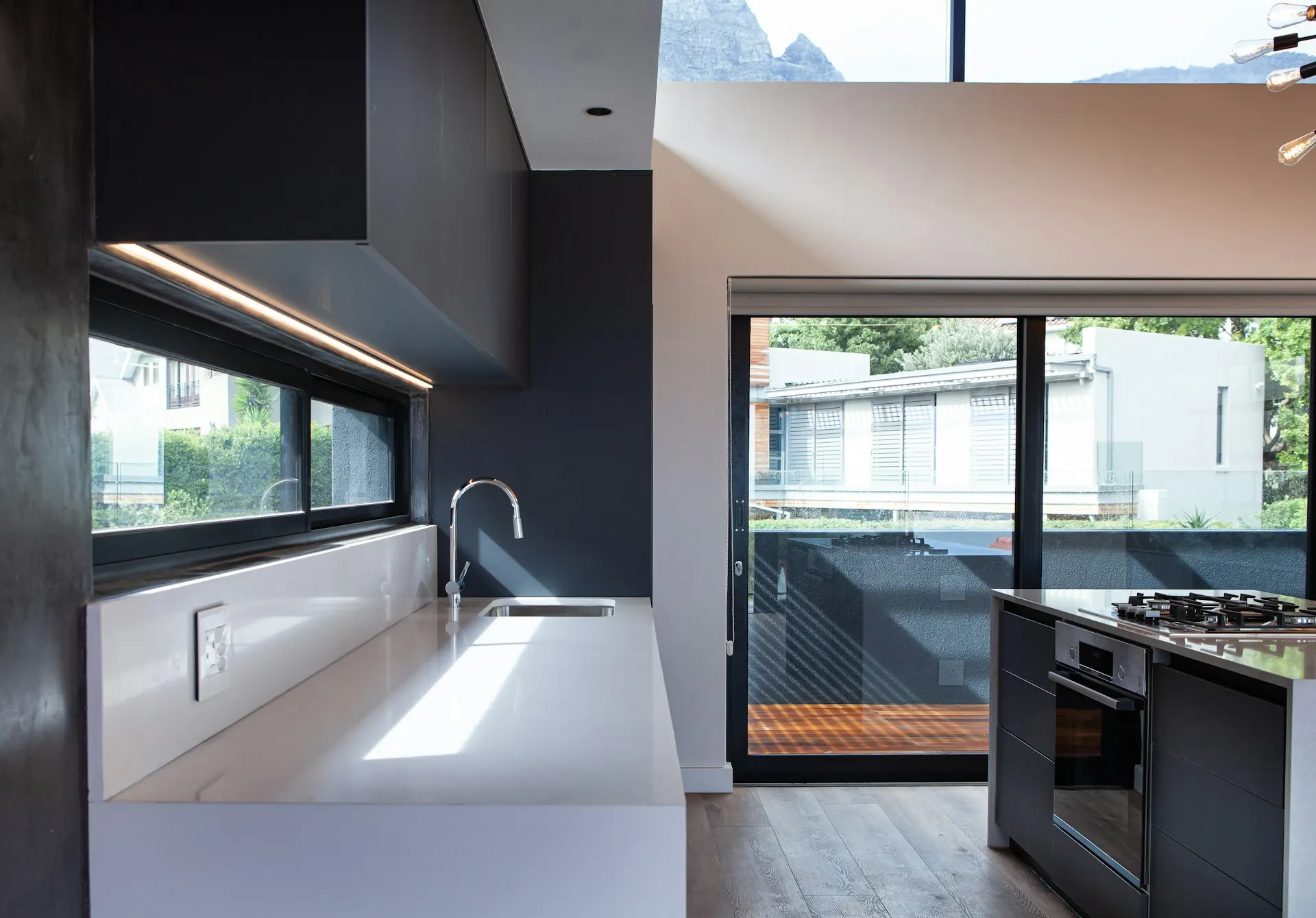 Modern kitchen with a long horizontal window and a sliding door to the patio