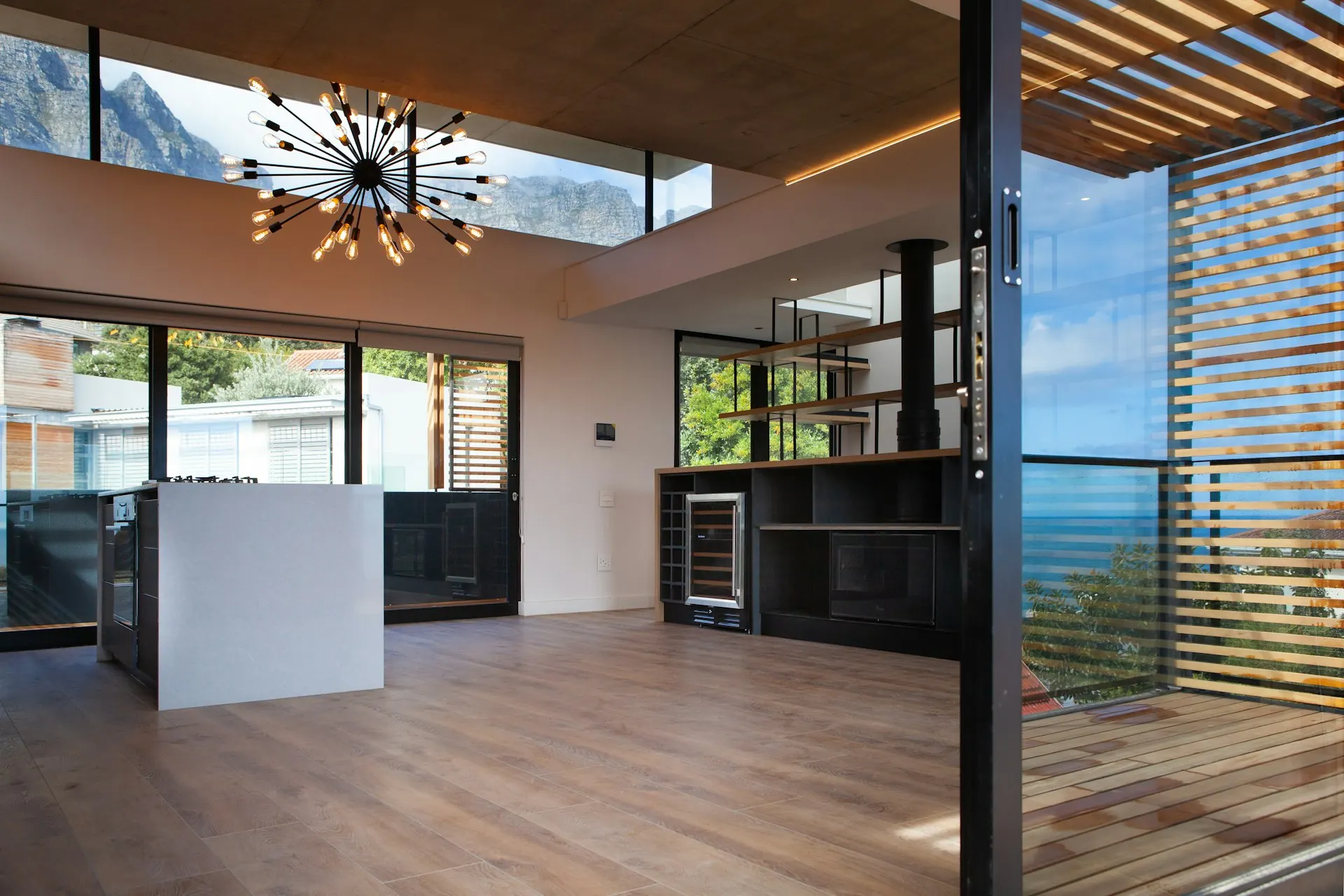 Open living space with floor-to-ceiling glass along the back wall