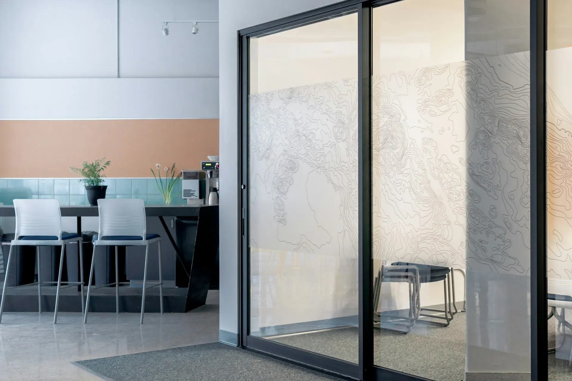 Black-framed sliding glass door beside a kitchen counter